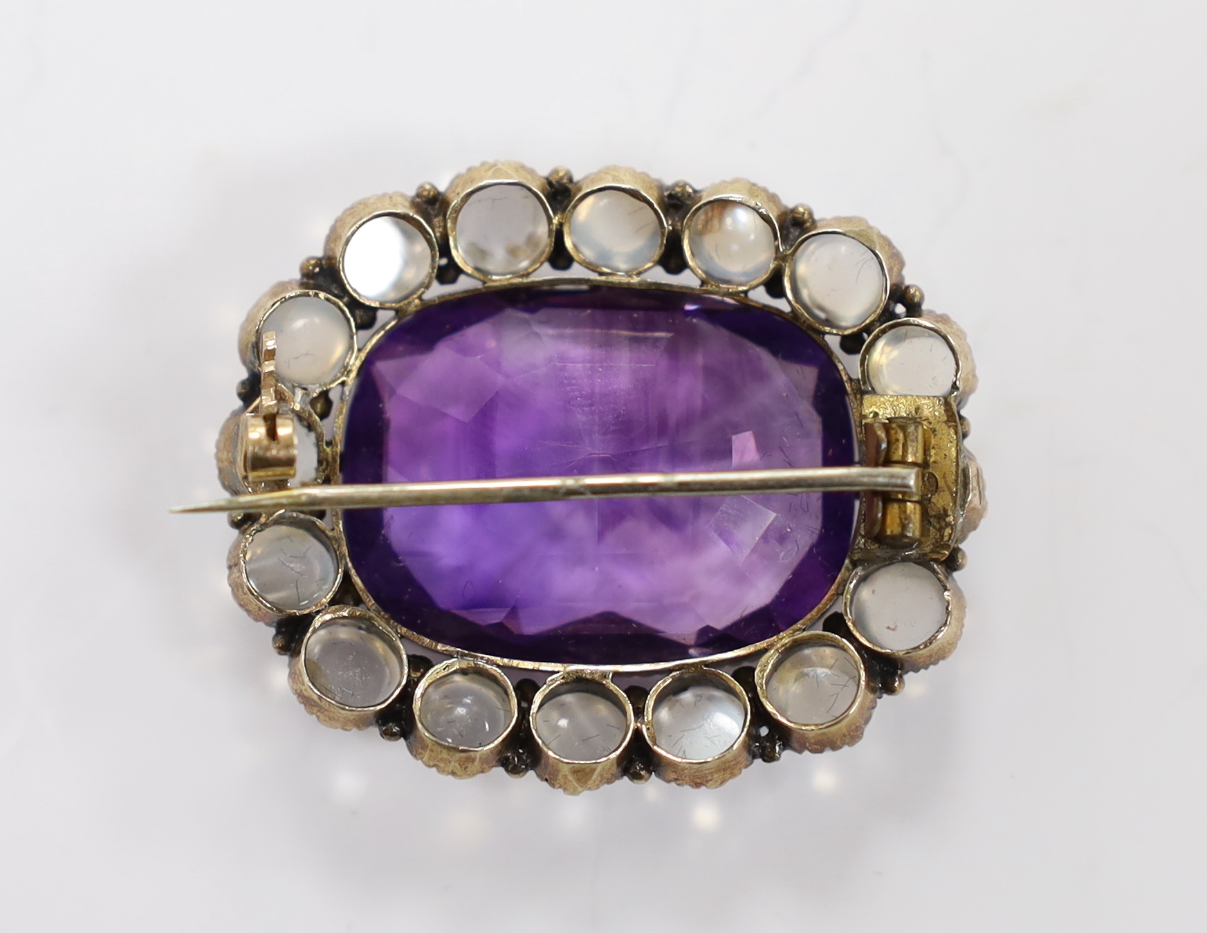 A yellow metal, amethyst and moonstone cluster set oval brooch, 34mm, gross weight 10.4 grams.